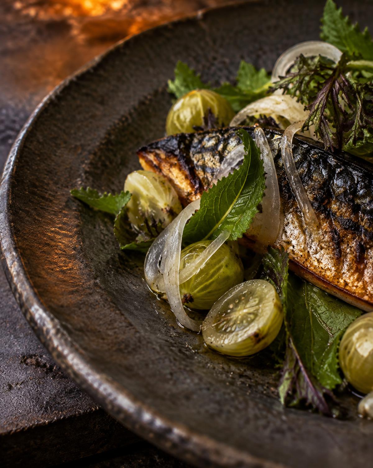 Fire-charred mackerel with gooseberries and mustard leaves